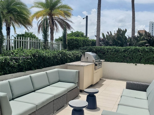 view of patio featuring area for grilling, exterior kitchen, and an outdoor living space