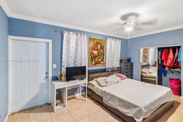 tiled bedroom with crown molding, a closet, and ceiling fan