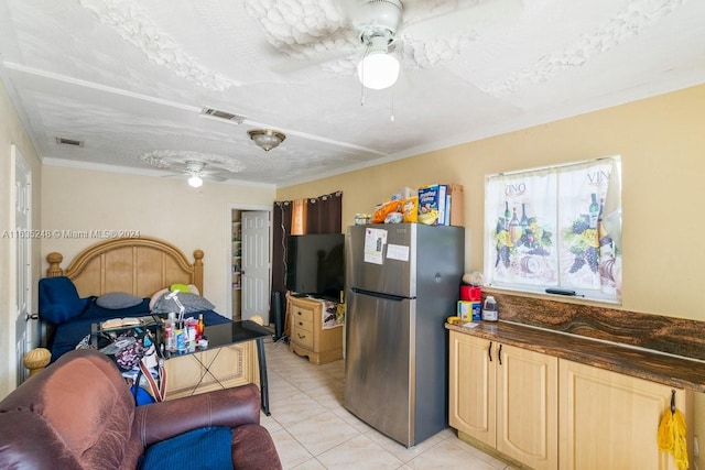 kitchen with light brown cabinets, stainless steel refrigerator, light tile patterned flooring, ceiling fan, and ornamental molding