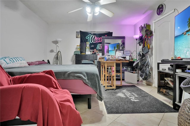 tiled bedroom featuring ceiling fan