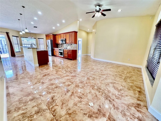 kitchen with stainless steel appliances, tasteful backsplash, an island with sink, vaulted ceiling, and decorative light fixtures