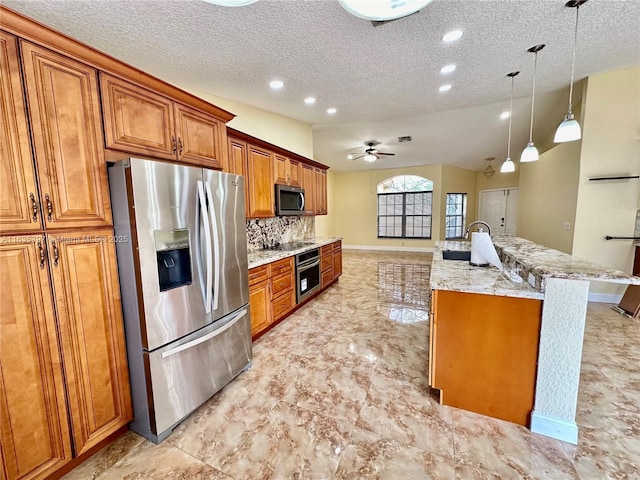 kitchen featuring decorative backsplash, appliances with stainless steel finishes, ceiling fan, pendant lighting, and lofted ceiling