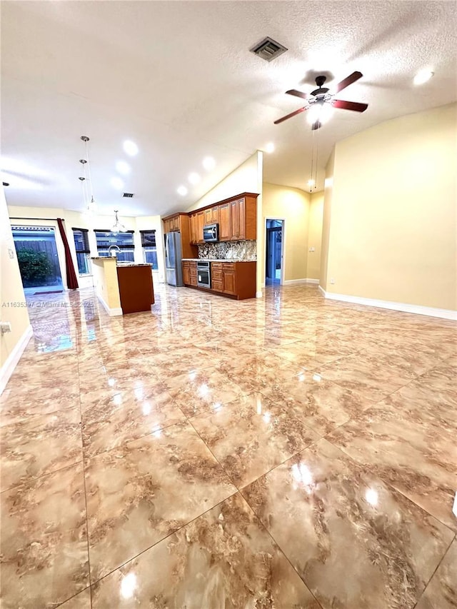 kitchen featuring backsplash, decorative light fixtures, stainless steel appliances, and lofted ceiling