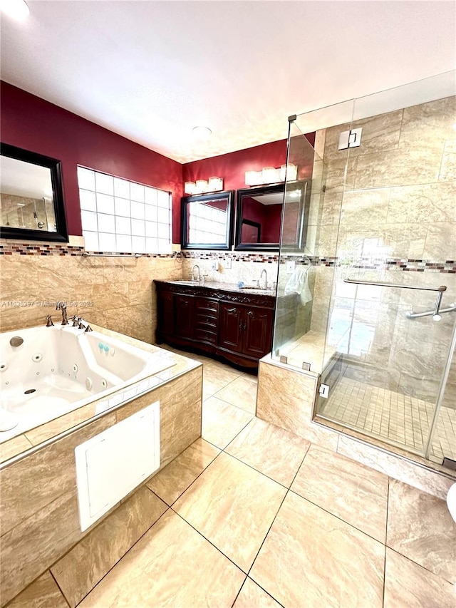 bathroom with tile patterned floors, vanity, and independent shower and bath