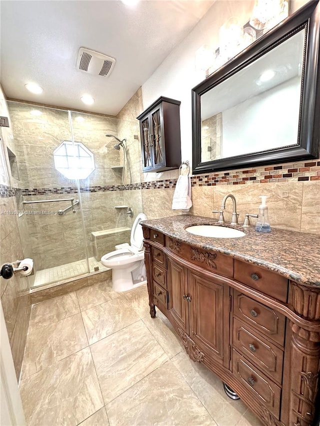 bathroom featuring backsplash, vanity, toilet, and walk in shower