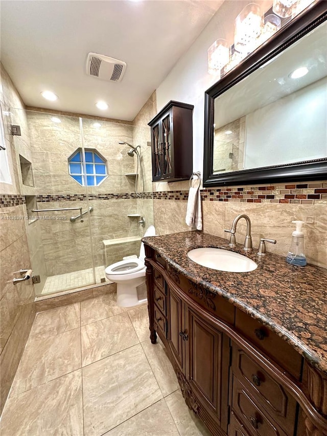 bathroom with vanity, toilet, and a shower with door