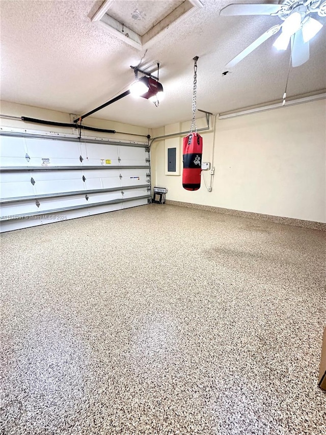 garage featuring ceiling fan, electric panel, and a garage door opener