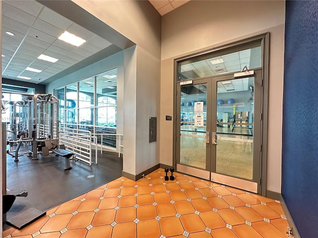 exercise room featuring a drop ceiling