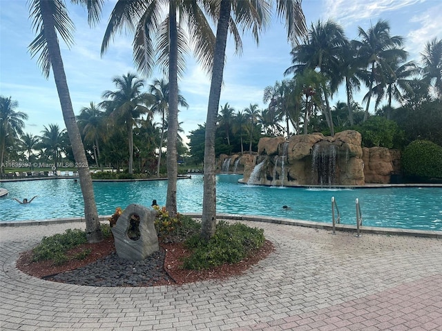 view of swimming pool featuring a water view