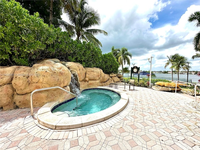 view of swimming pool featuring a water view