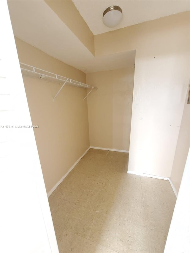 spacious closet featuring light tile patterned floors