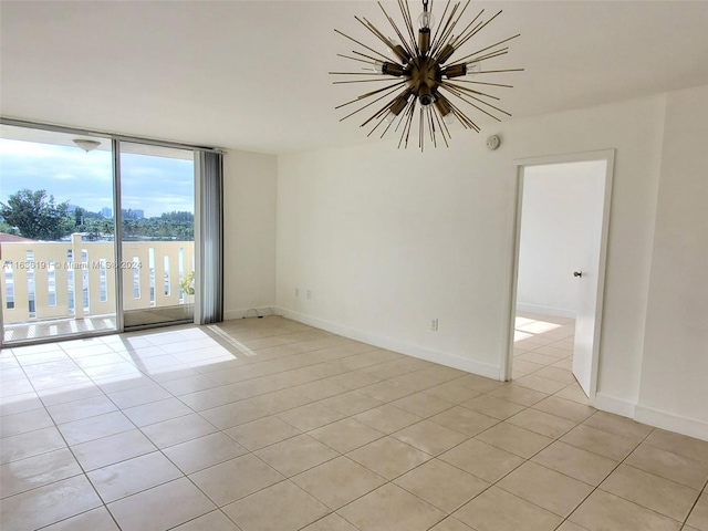 7900 Tatum Waterway Dr Unit 502, Miami Beach, FL 33141 - spare room with a chandelier, baseboards, and light tile patterned floors