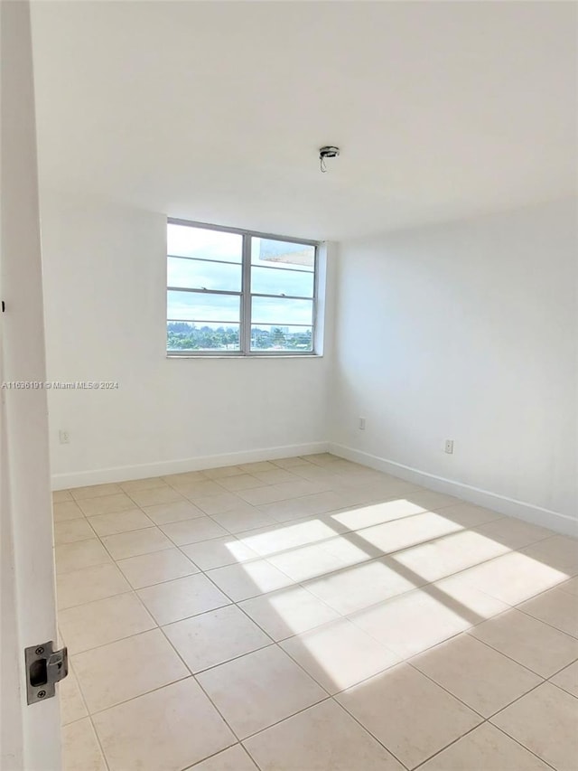 7900 Tatum Waterway Dr Unit 502, Miami Beach, FL 33141 - empty room with baseboards and light tile patterned floors
