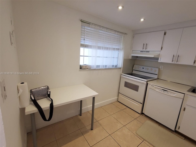 7900 Tatum Waterway Dr Unit 502, Miami Beach, FL 33141 - kitchen featuring under cabinet range hood, light tile patterned floors, white appliances, white cabinetry, and light countertops