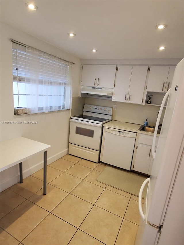 kitchen with sink, white cabinetry, white appliances, and light tile patterned floors