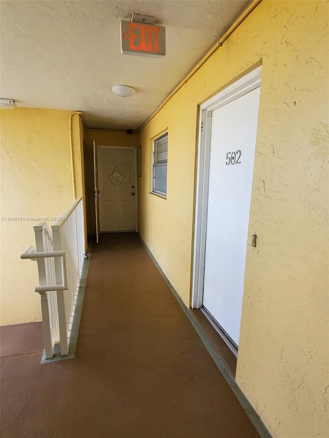 7900 Tatum Waterway Dr Unit 502, Miami Beach, FL 33141 - hallway featuring finished concrete flooring and a textured wall