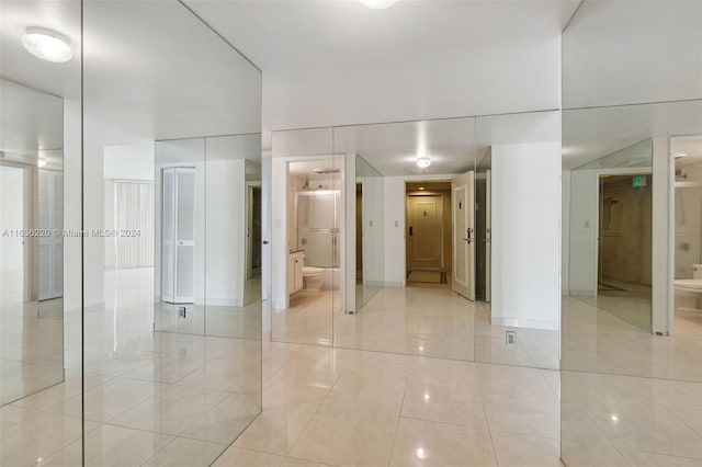 corridor with light tile patterned floors