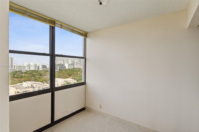 tiled empty room with a textured ceiling