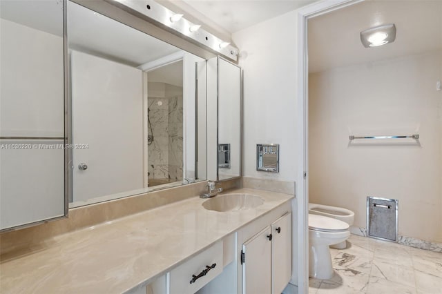 bathroom with vanity, tile patterned flooring, a bidet, and toilet