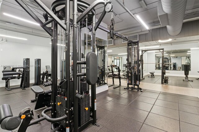 exercise room with tile patterned floors