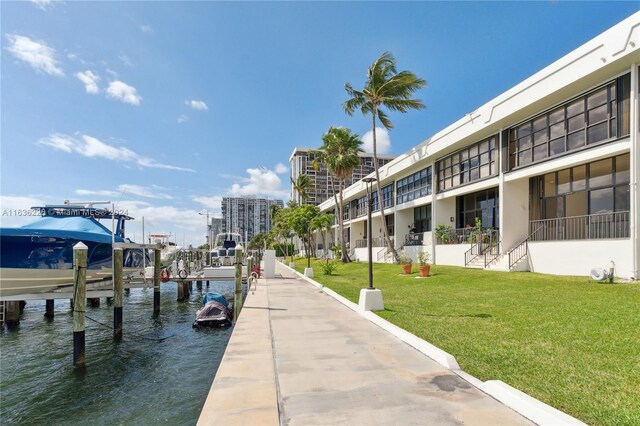 dock area featuring a water view and a yard