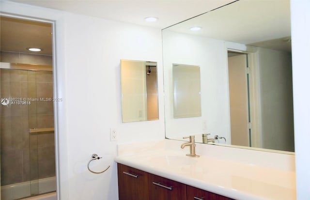 bathroom featuring an enclosed shower, recessed lighting, and vanity