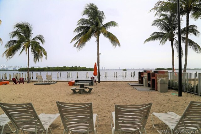 exterior space with a water view and a boat dock