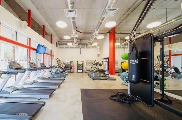 gym with a high ceiling and visible vents