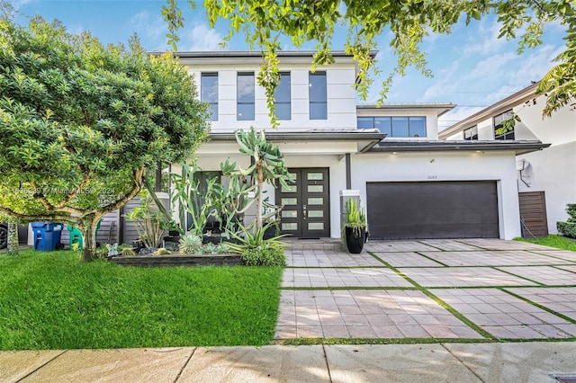 view of front of home with a garage and a front yard