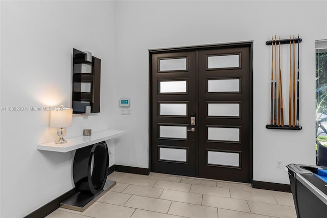 foyer with light tile patterned flooring and french doors