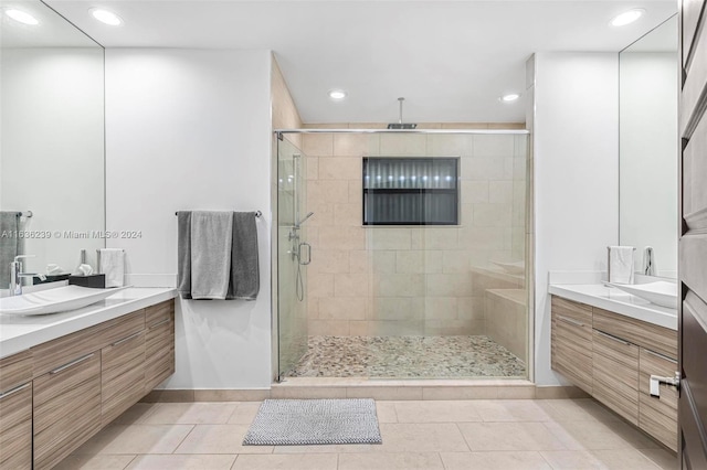 bathroom with walk in shower, tile patterned floors, and vanity