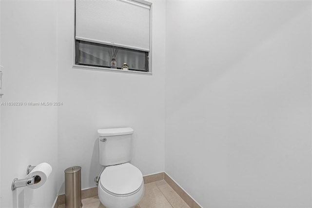 bathroom with tile patterned flooring and toilet