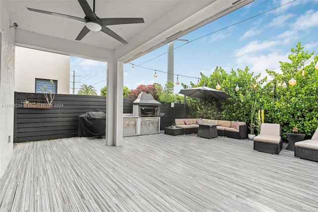 wooden terrace with outdoor lounge area, a grill, and ceiling fan