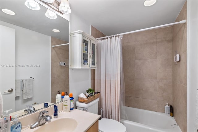 full bathroom with shower / bathtub combination with curtain, vanity, and toilet