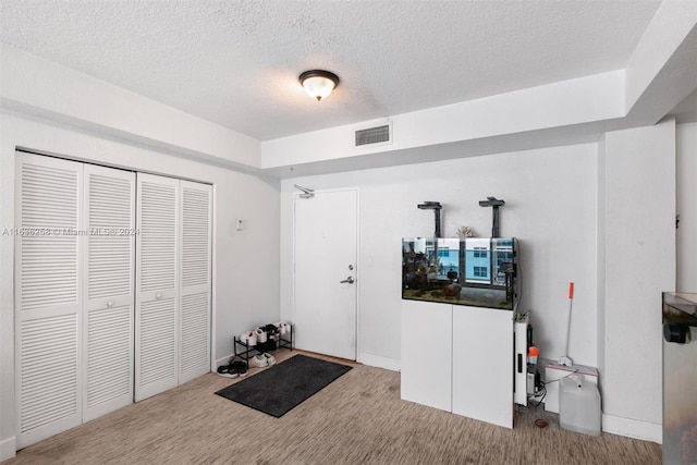 interior space featuring a textured ceiling and a closet