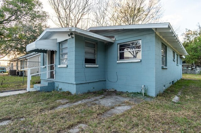 view of side of property with a yard