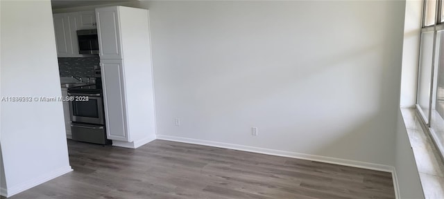 unfurnished dining area with wood-type flooring and sink