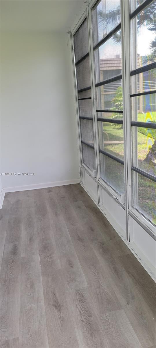 unfurnished room featuring dark wood-type flooring