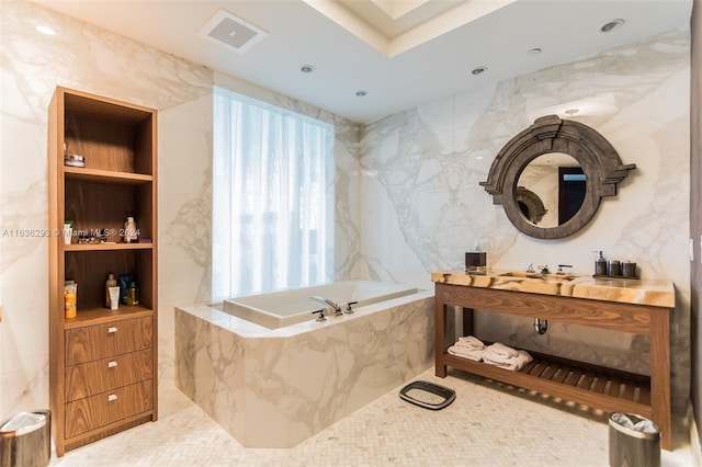 bathroom with built in features, tile walls, and tiled tub