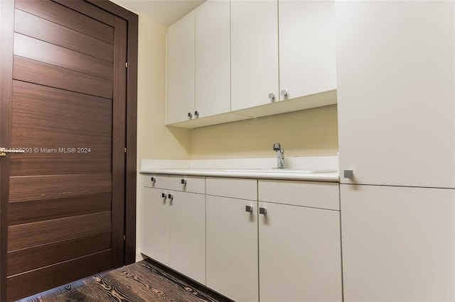 interior space with dark hardwood / wood-style flooring and sink