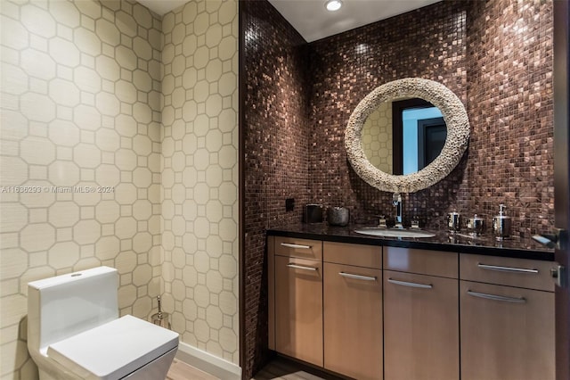 bathroom with hardwood / wood-style floors, vanity, and toilet