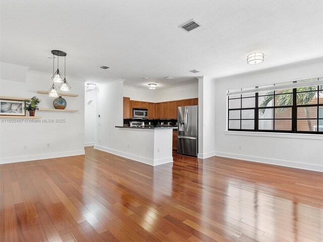 unfurnished living room featuring wood-type flooring and a textured ceiling