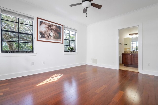 unfurnished room with crown molding, wood-type flooring, and ceiling fan