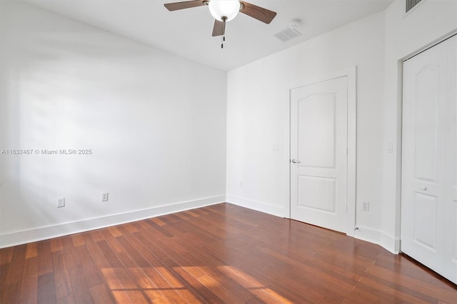 unfurnished room with ceiling fan and dark hardwood / wood-style floors