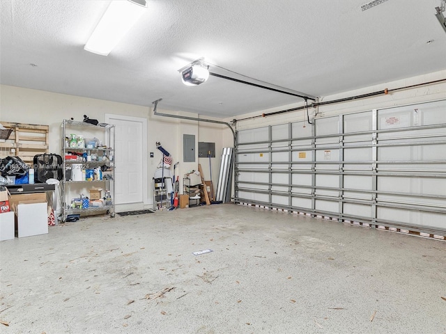 garage with a garage door opener and electric panel