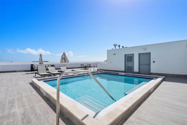 view of swimming pool featuring a patio