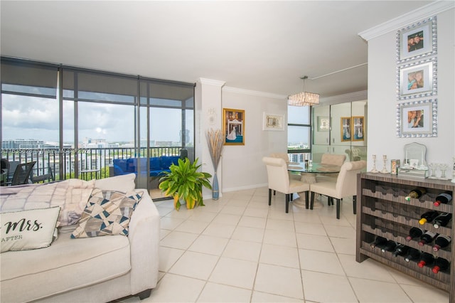 living room featuring a wealth of natural light, crown molding, and light tile patterned floors