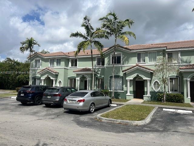 1519 SE 24th Ct Unit 238, Homestead, FL 33035 - view of front of property with stucco siding, uncovered parking, and a tiled roof
