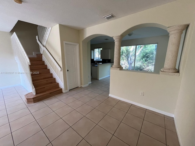 1519 SE 24th Ct Unit 238, Homestead, FL 33035 - interior space featuring visible vents, a textured ceiling, light tile patterned flooring, and decorative columns