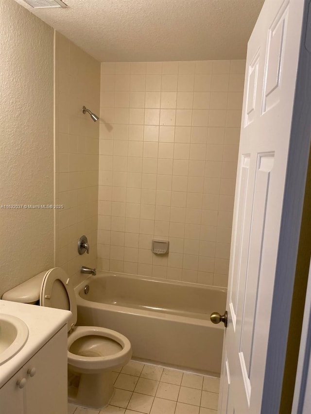 1519 SE 24th Ct Unit 238, Homestead, FL 33035 - bathroom featuring tile patterned flooring, toilet, a textured ceiling, and a textured wall